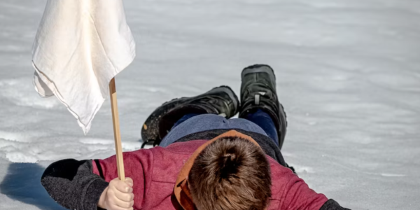 Man face down with white flag Man face down with white flag